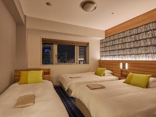 Ένα ή περισσότερα κρεβάτια σε δωμάτιο στο Hearton Hotel Nishi Umeda