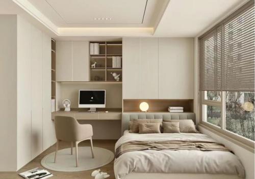 a bedroom with a bed and a desk and a monitor at Ơ Kìa Home in Da Nang