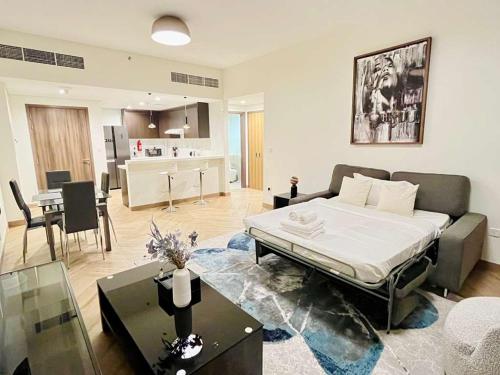 a large living room with a bed and a kitchen at Skyline 19 1 Residences in Dubai