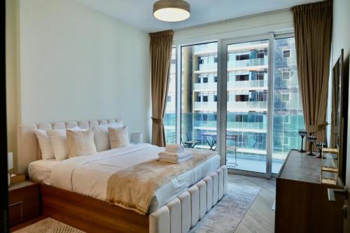 a bedroom with a large bed and a large window at Skyline 19 1 Residences in Dubai