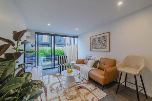 a living room with a couch and a table at Modern Addington Escape Stylish 2br Townhouse in Addington