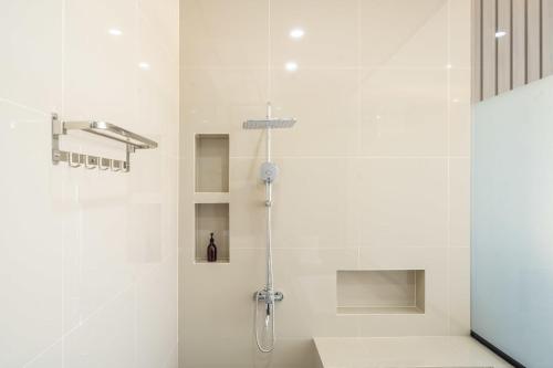 a shower in a bathroom with a glass door at Twin Room with Kitchen & Pool in Uluwatu - No 4 in Bingin Beach