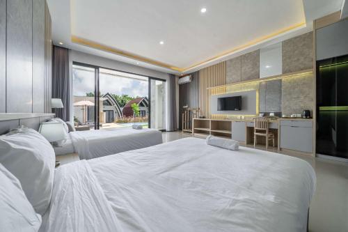 a bedroom with a large white bed and a kitchen at Twin Room with Kitchen & Pool in Uluwatu - No 4 in Bingin Beach