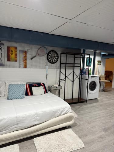 a bedroom with a bed and a washing machine at Nice and Cozy! in Lincoln