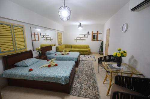 a living room with two beds and a couch at Giza City Hotel-الجيزة سيتى اوتيل in Cairo