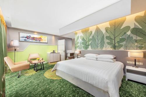 a hotel room with a bed and a chair at Sunway Velocity Hotel Kuala Lumpur in Kuala Lumpur