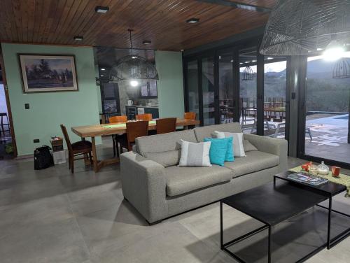 a living room with a couch and a table at Relax en San Nicolás in Villa San Nicolás