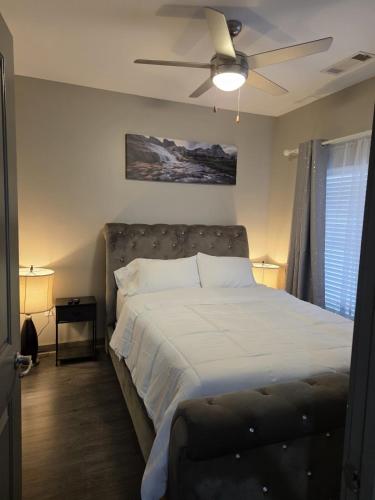 a bedroom with a bed with a ceiling fan at Gorgeous Uptown Apartment with Pool in Charlotte