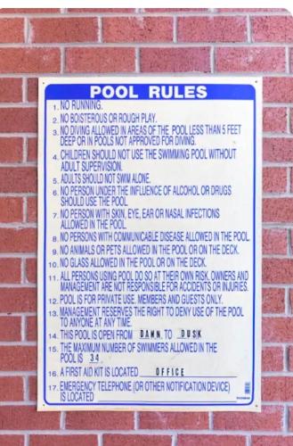 a sign on the side of a brick wall at Gorgeous Uptown Apartment with Pool in Charlotte