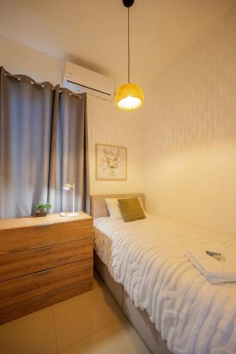 a small bedroom with a bed and a window at Casa Atara in Flores