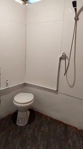 a bathroom with a white toilet in a stall at Koh Ngai Seafood in Ko Ngai