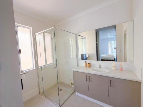 a bathroom with a sink and a glass shower at Brabham Modern Stay Close to Swan Valley in West Swan