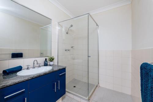 a bathroom with a sink and a shower at WELL82 - Ocean Heights in Mosman Park