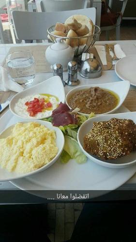 a tray with plates of food on a table at Giza City Hotel-الجيزة سيتى اوتيل in Cairo