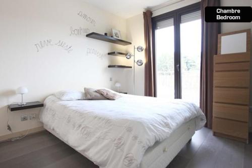 une chambre avec un lit blanc avec une fenêtre dans l'établissement Coeur de Cannes - 2 pièces moderne, à Cannes