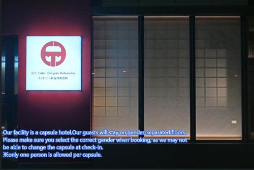 a sign on the side of a building with a window at ELE Cabin Shinjuku Kabukicho in Tokyo