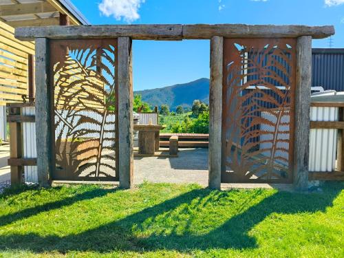 a gate to a garden with a view at Maungatapu Hut in Rai Falls
