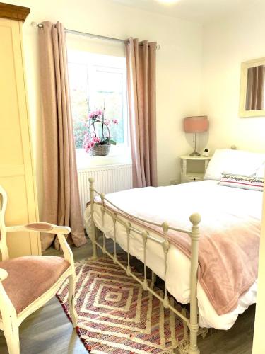 a bedroom with a large bed and a window at Newcastle Pet friendly 1 bed drive garden 10m city in Kenton