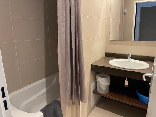 a bathroom with a shower curtain and a sink at Studio 6 pers à Gourette avec terrasse - FR-1-860-19 in Gourette
