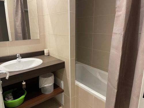a bathroom with a sink and a bath tub at Studio cabine 7 pers, piscine, animaux admis, Gourette - FR-1-860-22 in Gourette