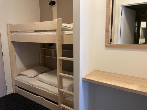 a room with bunk beds in a room with a mirror at Charmant studio à Gourette avec piscine et animaux admis, pour 6 personnes - FR-1-860-26 in Gourette