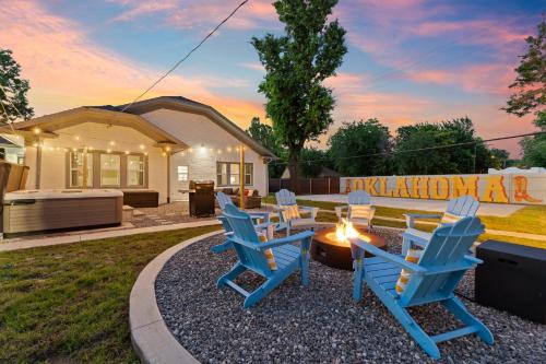 a group of blue chairs sitting around a fire pit at 5 Beds Downtown OKC - Pickleball, Hot Tub, Firepit, GameRoom in Oklahoma City
