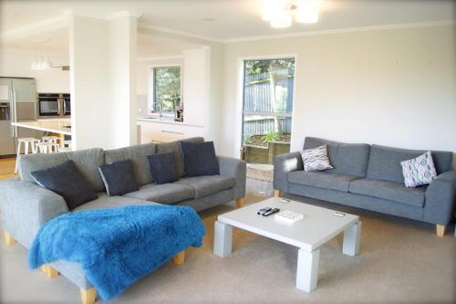 a living room with two couches and a coffee table at Magic on Molesworth - 2BR townhouse near CBD in New Plymouth