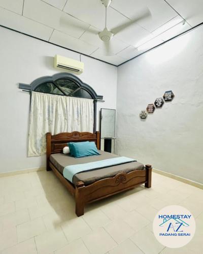 a bedroom with a bed in a room at Homestay AZ Padang Serai in Padang Serai