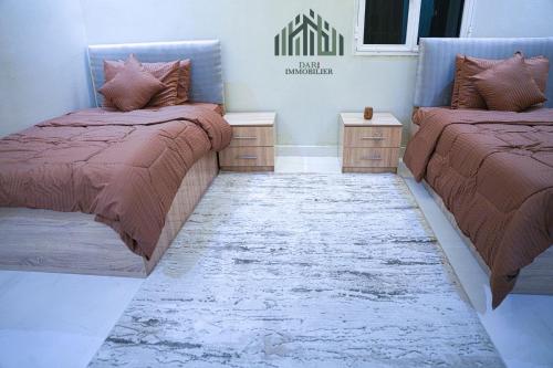 two beds sitting next to each other in a room at Modern and spacious luxury villa for rent 2 bedrooms in Nouakchott