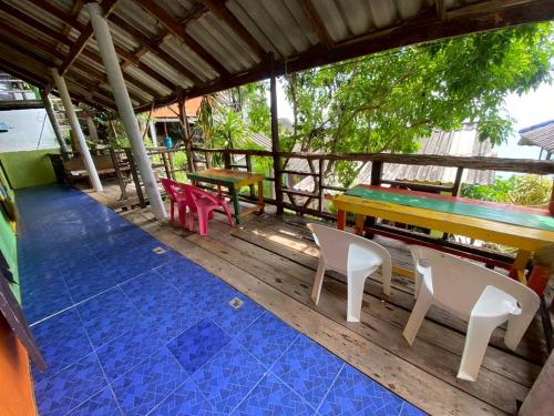a wooden deck with a table and chairs on it at maylamean bungalows kohchang in Ban Khlong Son