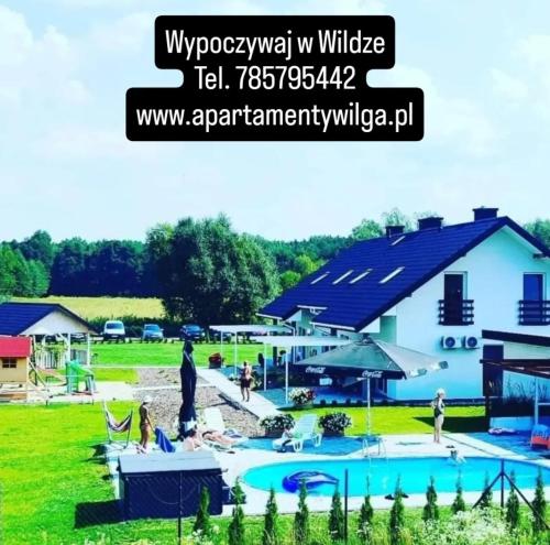 a house with a swimming pool in a yard at Apartamenty Wilga - spokojne miejsce z całorocznym zewnętrznym wspólnym jacuzzi, sauną i letnim basenem in Wilga