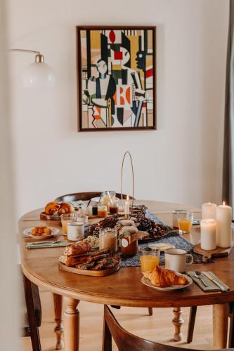a table with food and candles on top of it at Domaine des Pousses, Chambres d'hôtes au coeur d'un village de campagne in Droue-sur-Drouette
