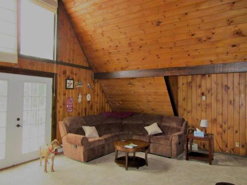 a living room with a couch and a table at Charming Cabin Retreat in the Foothills of the Adirondacks in Fort Ann, New York in Fort Ann