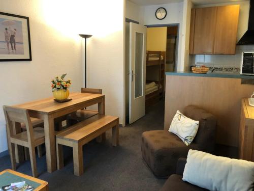 ein Wohnzimmer mit Tisch und Küche in der Unterkunft Studio confort à Gourette pour 4 pers, animaux admis - FR-1-859-15 in Gourette