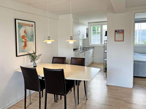 a kitchen and dining room with a table and chairs at 4 person holiday home in Svaneke in Svaneke