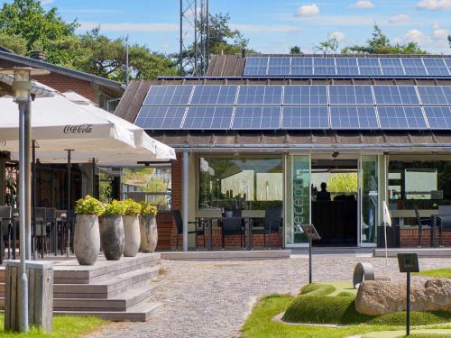 a building with solar panels on top of it at 6 person holiday park home in Gilleleje in Gilleleje