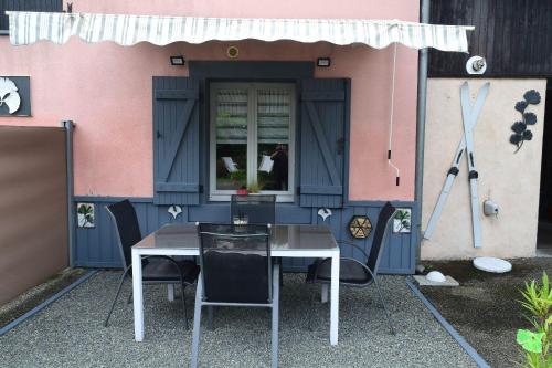 a table and chairs in front of a house at Gite le GINKGO 50 M2 in Rougegoutte
