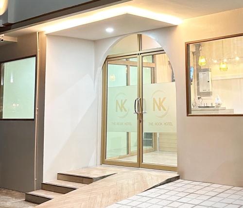 an entrance to a store with a large window at The Nook Hotel in Chiang Mai