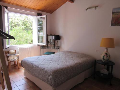 a bedroom with a bed and a window at Maison familiale avec jardin, à 1km de la plage - FR-1-194-308 in La Faute-sur-Mer