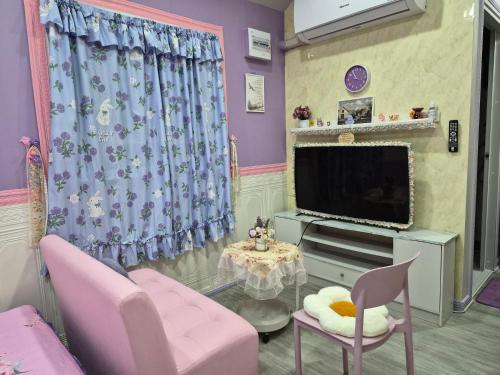 a living room with pink chairs and a tv at Blessing Homestay Mae-On แม่ออน Chiang Mai in Ban On Luai