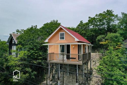 a small house on top of a hill with trees at ist villa 03 Seaside Cabin Sleeps 5 in Bizen