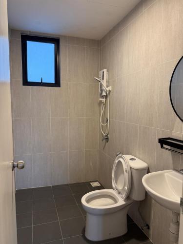 a bathroom with a toilet and a sink and a window at MKH Boulevard 2, Kajang in Kajang