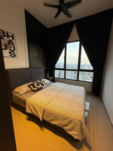 a bedroom with a large bed with a ceiling fan at MKH Boulevard 2, Kajang in Kajang