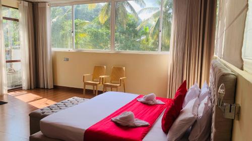 Postel nebo postele na pokoji v ubytování Royal Retreat ,Kandy
