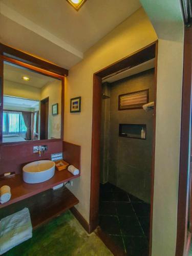 a bathroom with a sink and a shower at Retreat Siargao Resort in General Luna
