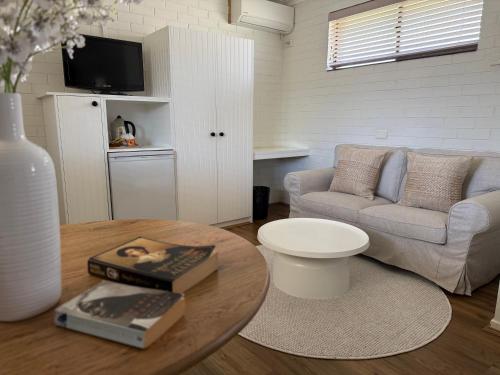 a living room with a couch and a table at Ballina Travellers Lodge in Ballina