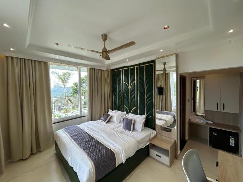 um quarto com uma cama e uma janela grande em Munnar Peak Paradise em Devikolam