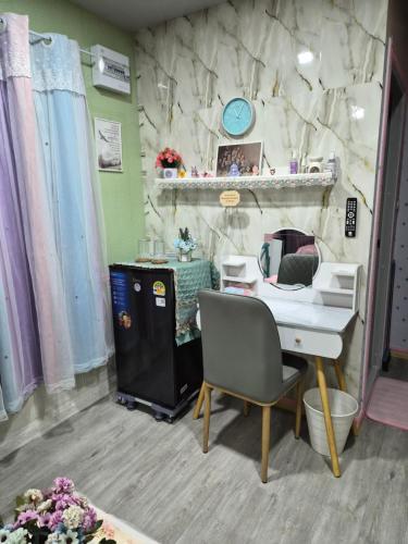 a desk and a chair in a room with a stone wall at Blessing Homestay Mae-On แม่ออน Chiang Mai in Ban On Luai