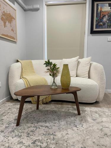 a living room with a couch and a vase on a coffee table at Kellyville Ridge 2 Bedroom Granny Flat in Glenwood