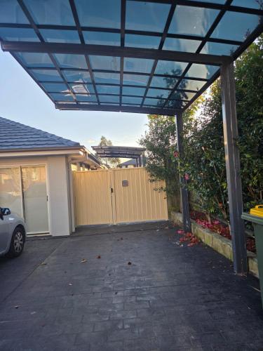 a pergola over a driveway of a house at Kellyville Ridge 2 Bedroom Granny Flat in Glenwood
